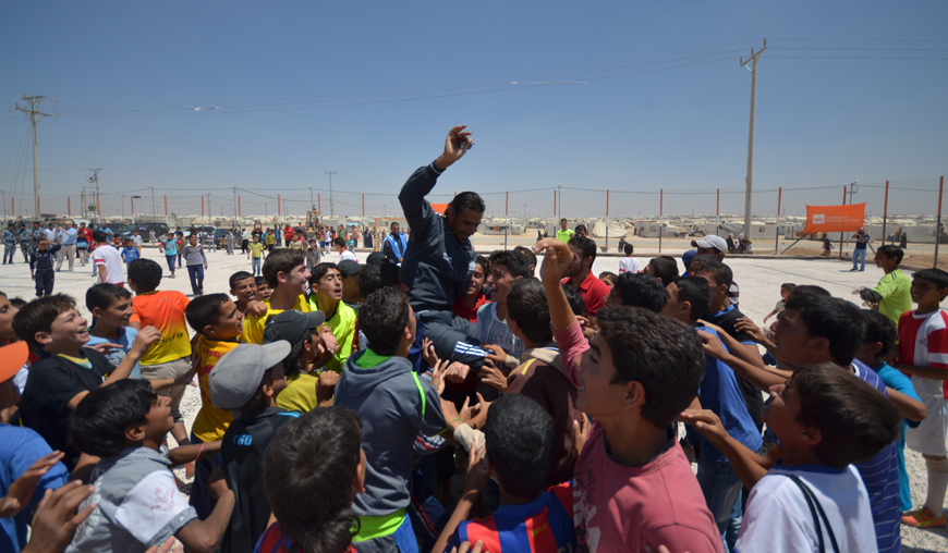 Syrian football players at the Zaatari Refugee Camp carry their coach in celebration of winning a tournament that concluded on Monday (Photo by Muath Freij)
